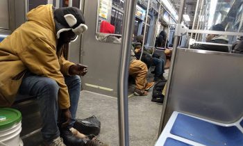 Man Gives The Boots Off His Feet To A Homeless Man On The Subway